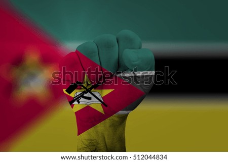 Man hand fist of MOZAMBIQUE flag painted