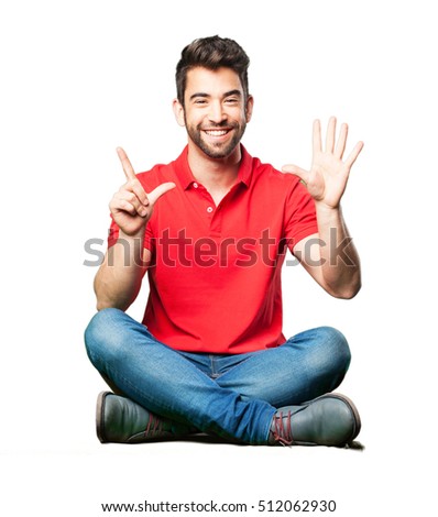 man sitting doing number seven gesture