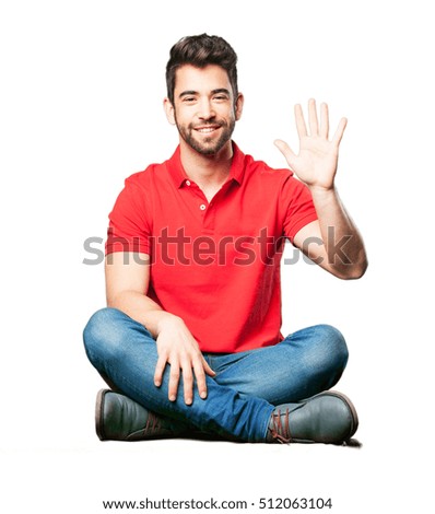 man sitting doing number five gesture