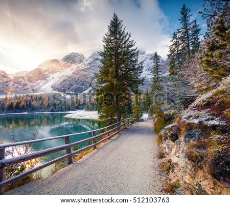 First snow on Braies Lake. Colorful autumn sunrise in Italian Alps, Naturpark Fanes-Sennes-Prags, Dolomite, Italy, Europe. Artistic style post processed photo.
