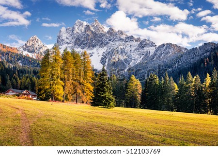 Sunny view of Durrenstein mountain from Vallone village. Colorful autumn scene in the Dolomite Alps, Province of Bolzano - South Tyrol, Itale, Europe. Artistic style post processed photo.