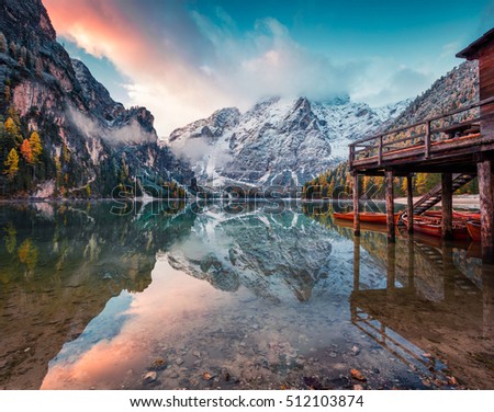 Boat hut on Braies Lake with Seekofel mount on background. Colorful autumn landscape in Italian Alps, Naturpark Fanes-Sennes-Prags, Dolomite, Italy, Europe. Artistic style post processed photo.
