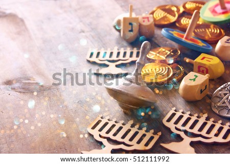Image of jewish holiday Hanukkah with wooden dreidels colection (spinning top) and chocolate coins