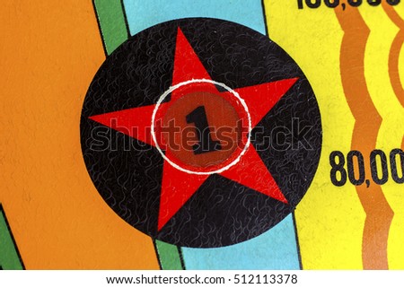 Number 1 star decal light on pinball machine Royalty-Free Stock Photo #512113378