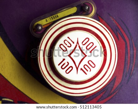 Overhead of 100-point bumper on retro pinball machine Royalty-Free Stock Photo #512113405