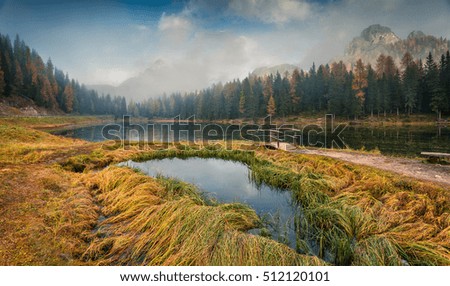 Misty outdoor scene on Antorno lake. Colorful autumn morning in Dolomite Alps, National Park Tre Cime di Lavaredo, Italy, Europe. Artistic style post processed photo.