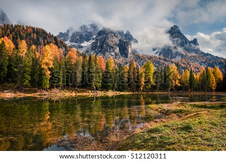 Sunny outdoor scene on Antorno lake. Colorful autumn morning in Dolomite Alps, National Park Tre Cime di Lavaredo, Italy, Europe. Artistic style post processed photo.
