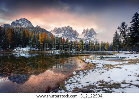 Dramatic sunrise on Antorno lake. Colorful autumn morning in Dolomite Alps, Province of Belluno, Italy, Europe. Artistic style post processed photo.
