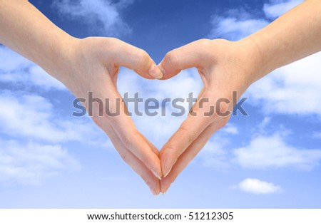 Heart combined from hands on blue background