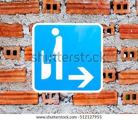 restroom signs on brick wall