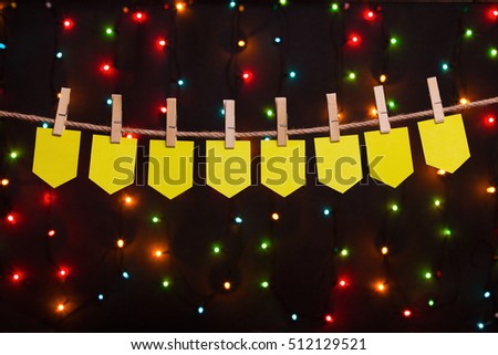 eight festive flags on the background of colored lights