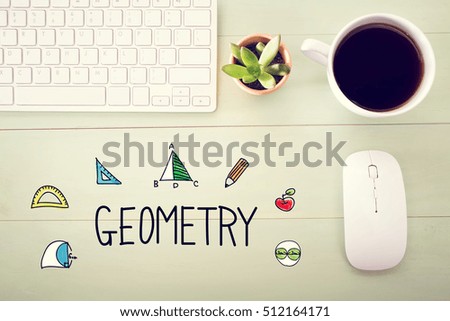 Geometry concept with workstation on a light green wooden desk