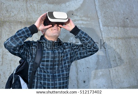 Teen playing with glasses of reality virtual in the street