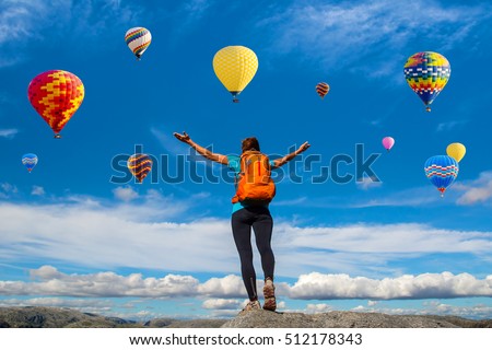Amazing view with sport girl and a lot of hot air balloons. Artistic picture. Beauty world. The feeling of complete freedom
