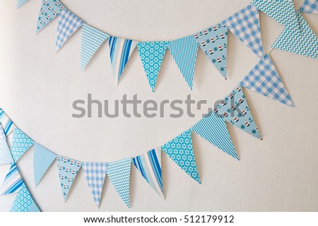 White wall decorated by colorful cartoon flag for children