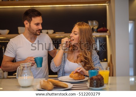 Couple eating a breakfast together at home.