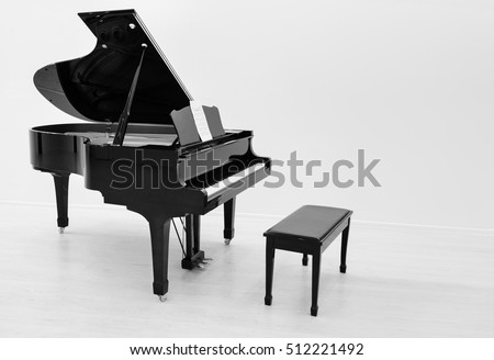 Black and white image of the piano is ready to play in a bright room