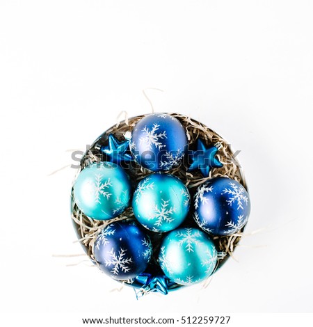 round box with bright blue christmas balls on white background. flat lay, top view