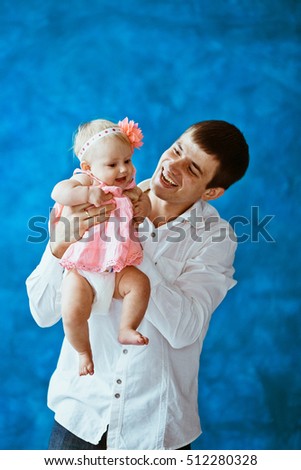 The father hold on hands his daughter