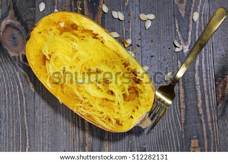 Overhead view of Spaghetti squash on a wooden background with squash seeds Royalty-Free Stock Photo #512282131
