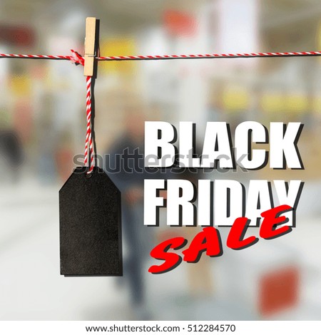 Black friday. Black sale tag on the background of shopping mall interior, shallow depth of focus
