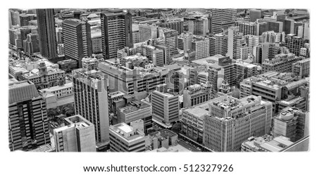 Amazing urban landscape from aerial view. Wonderful old black & white photo. Nice retro vintage. Skyscrapers in big city. City life. Awesome vintage image of Megalopolis. Beautiful high-rise buildings
