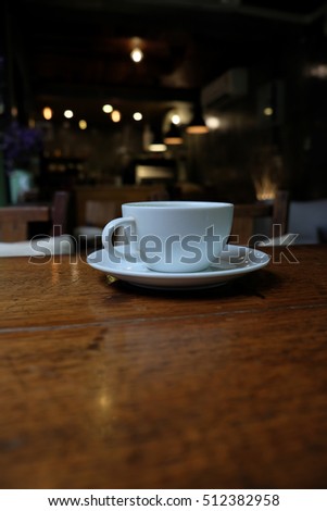 Coffee cup in coffee on table in cafe