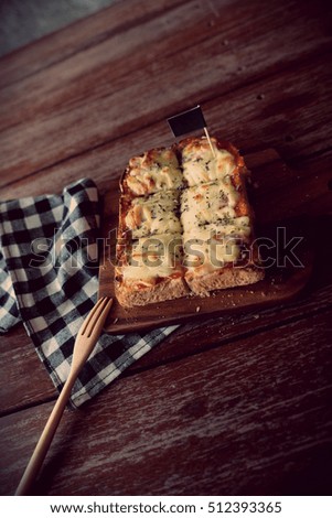 Pizza toasted bread with tomato sauce and ham cheese selective focus, picture vintage style