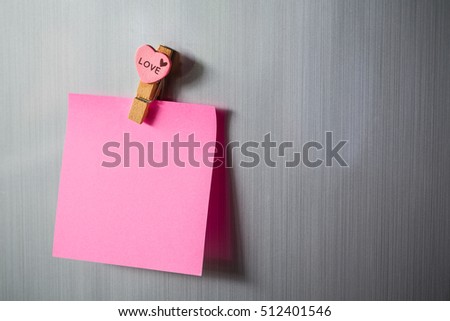 Abstract of wooden heart clip with Blank paper and stick paper on refrigerator door. paper note copy space for add text. valentine picture message background