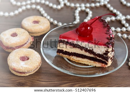 Delicious chocolate-cherry cake on plate on table