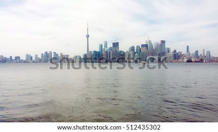 Toronto Skyline with cloudy sky at dusk with CN tower. Ontario, Canada