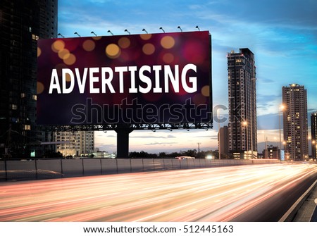 Billboard outdoor advertising on the highway during the twilight with text advertising on bokeh background - can be used for trade shows or promotional poster.