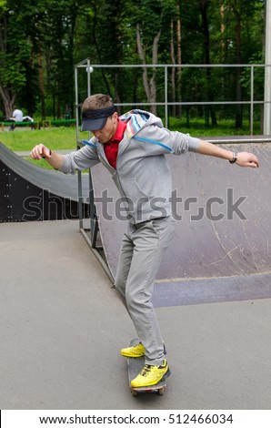 Young man with the skateboard in the park