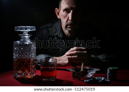 man smoke pipe and play poker