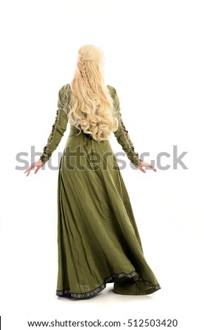full length portrait of a beautiful lady with long blonde hair wearing a green medieval fantasy gown. standing pose, isolated on white background. Royalty-Free Stock Photo #512503420