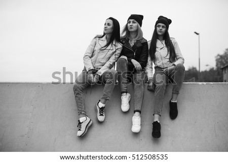 Happy three teen friends. Stylish girls in the autumn park posing.
