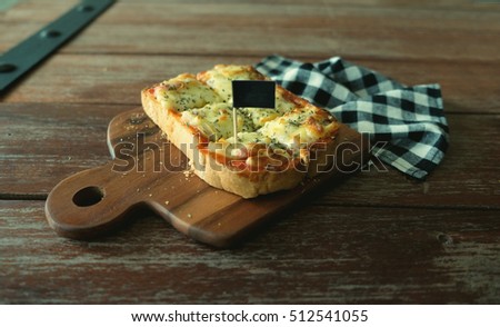 Pizza toasted bread with tomato sauce and ham cheese selective focus, picture vintage style