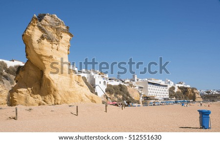 The beach of Albufeira - Southern Portugal. The picture  also shows how erision over time must have changed the coastline, leaving a tall heap of the old landscape as a "statue" on the beach.