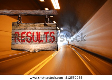 results motivational phrase sign on old wood with blurred background