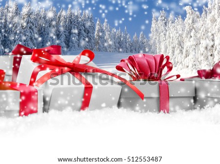 Photo of gifts with colorful ribbons, falling snow and white space