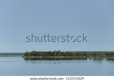 big beautiful lake with the islands under the clear blue sky