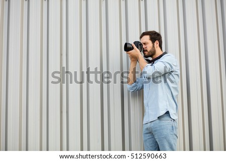 photographer taking a picture , standing on a gray background