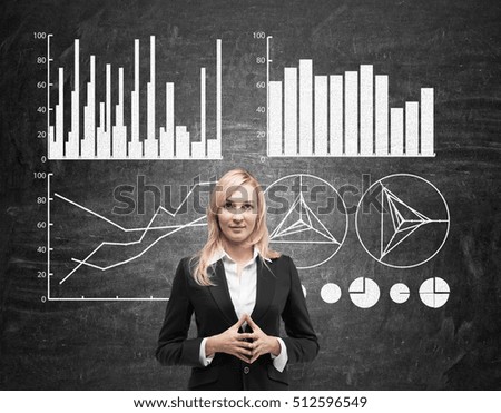 Serious blond woman is standing near blackboard with her fingers together. Four graphs are seen behind her. Concept of statistics