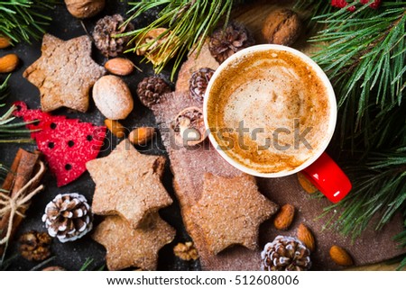 Christmas decoration with spice coffee and homemade gingerbread , ornaments, fir, cones on rustic  background. Retro style dark colored picture, top view