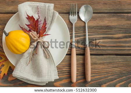 Autumn table setting on wooden background, top view.