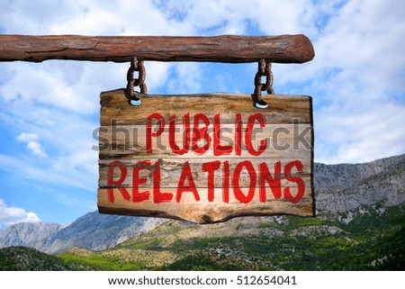 Public relations motivational phrase sign on old wood with blurred background