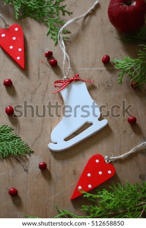 handmade hanging wooden skates ornament, red and white farmhouse christmas tree decoration. rustic nordic scandinavian country cottage style decor idea. winter still life. christmas card