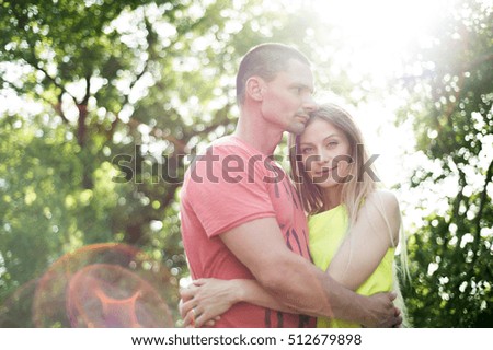 Beautiful young couple in love. Sunny summer nature.