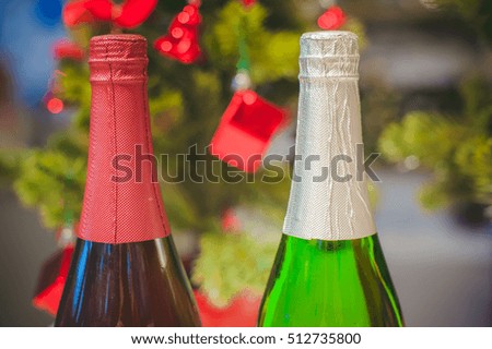 bottle of champagne on the background of the Christmas tree, blurred bokeh. the atmosphere of the New Year holiday table, anticipation