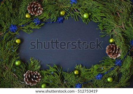 Border, frame from christmas tree branches with pine cones and blue berries